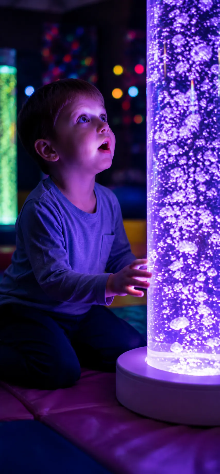 Child looking toward sensory bubbles